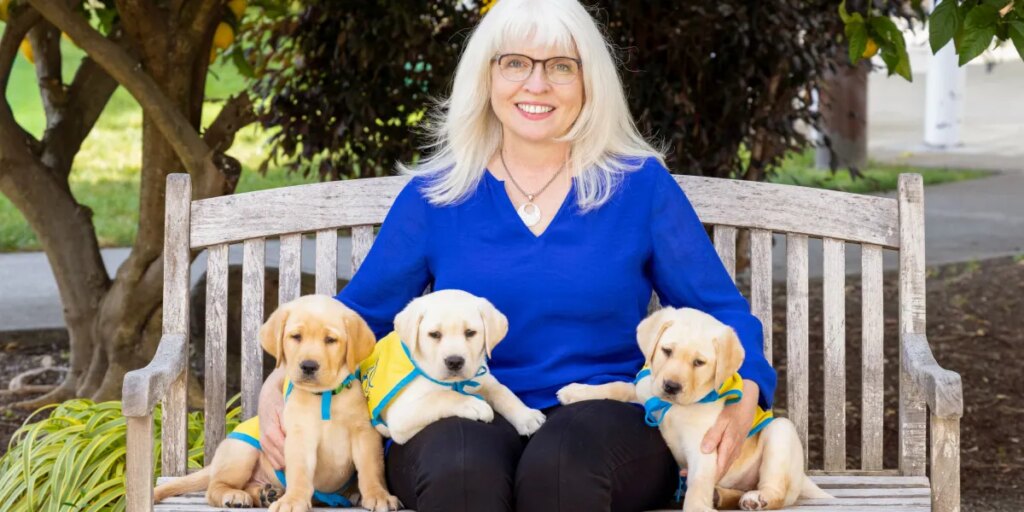 brenda kennedy with 3 puppies photo credit chris kittredge.jpg